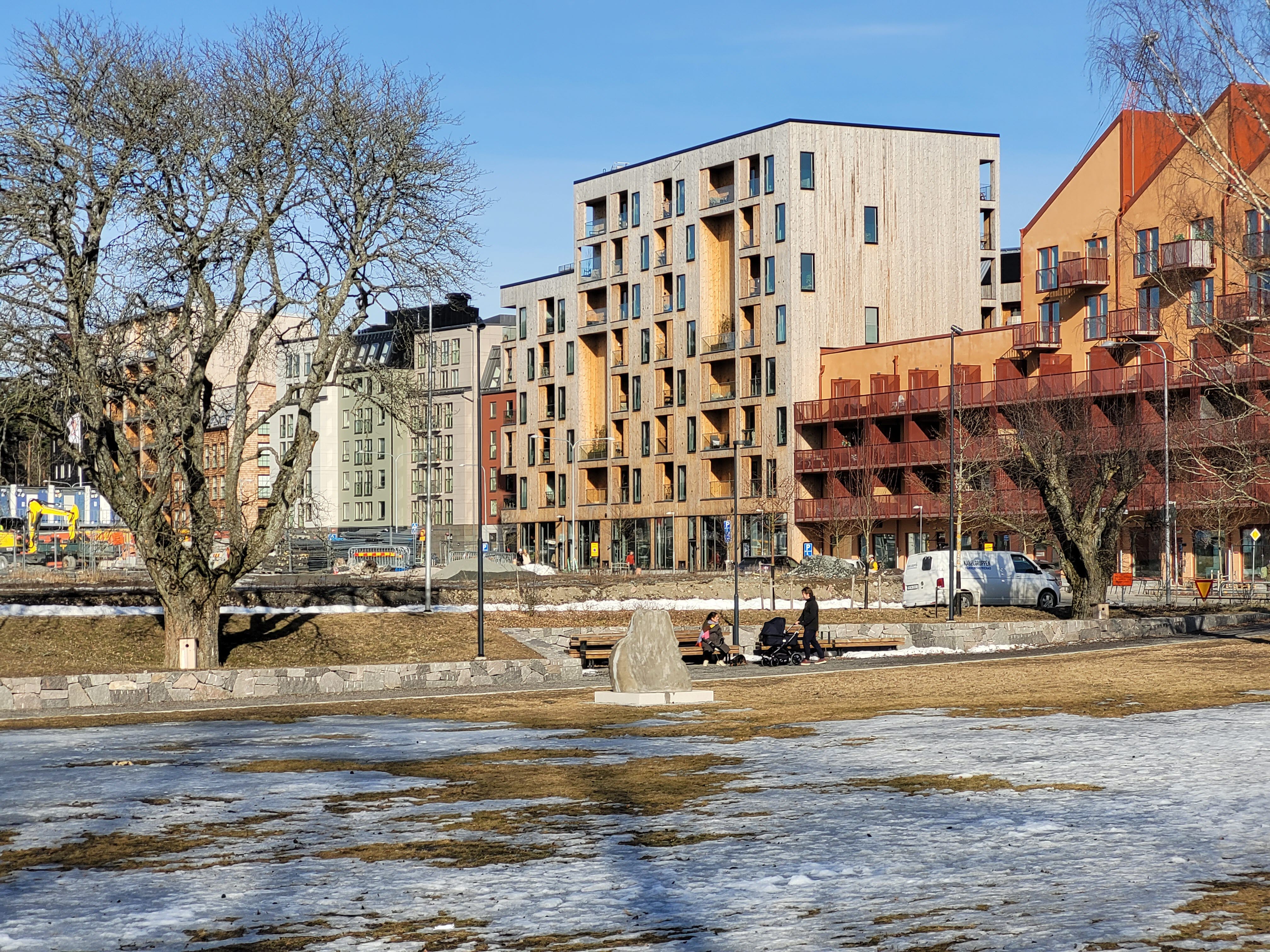 Torgbildning med flerfamiljshus i bakgrunden.