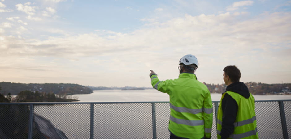 Two persons in high visibility cloything.